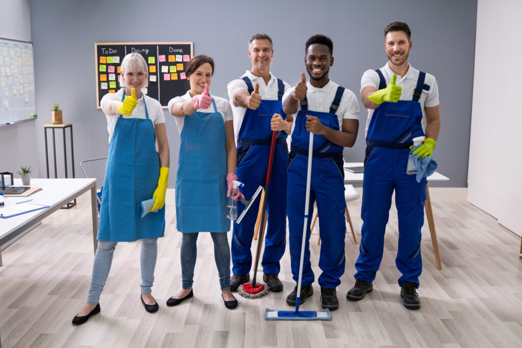 Janitors Showing Thumb Up Sign In The Office