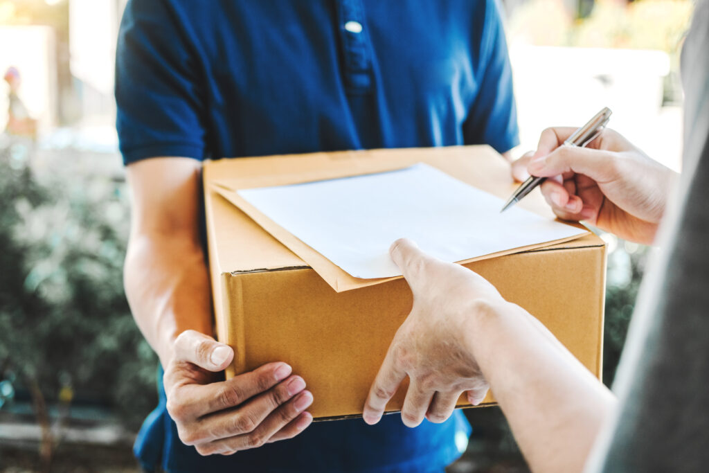Delivery concept Asian Man hand accepting a delivery boxes from